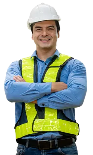 A plant supervisor in a hard hat and hi-vis vest, arms folded